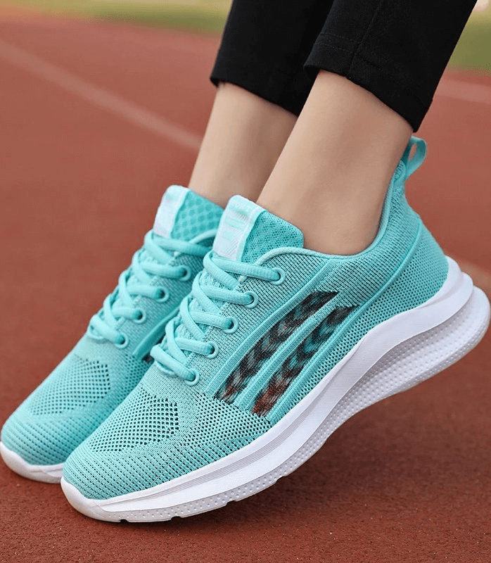 Sporty mesh breathable women's shoes SF0212 on running track, durable EVA outsole, ideal for training and running in style.